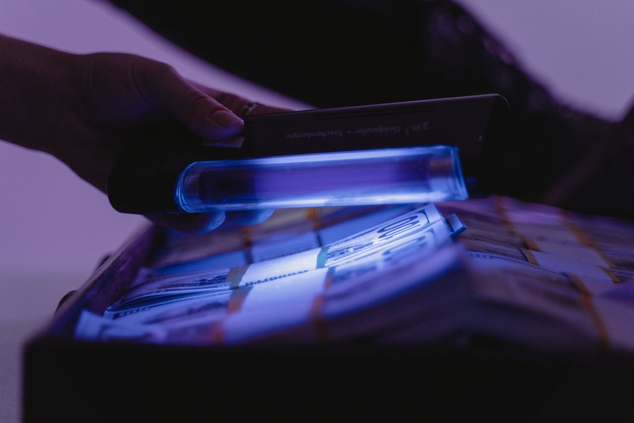home-hero A close-up shot of banknotes under UV light to verify currency authenticity and detect counterfeits.
